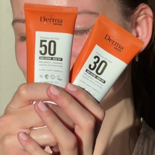 Derma Supreme Face Fluids SPF30 + SPF50 i kvindehænder